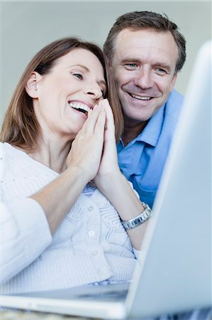 simsearch:649-06717020,k - Couple using laptop in armchair Stock Photo - Premium Royalty-Free, Code: 6122-07705030