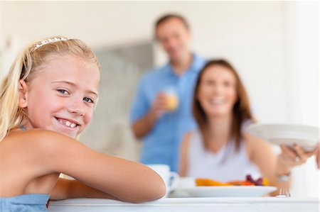 simsearch:649-05656972,k - Smiling girl sitting at table Stock Photo - Premium Royalty-Free, Code: 6122-07705037