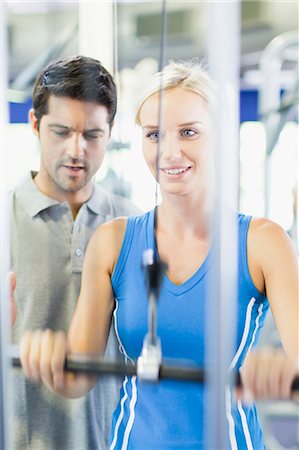 Woman working with trainer in gym Stock Photo - Premium Royalty-Free, Code: 6122-07705123