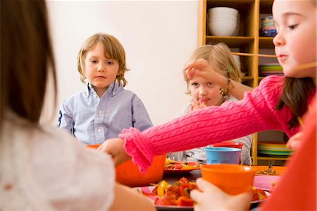 simsearch:6122-07706771,k - Children eating together at table Stock Photo - Premium Royalty-Free, Code: 6122-07705266