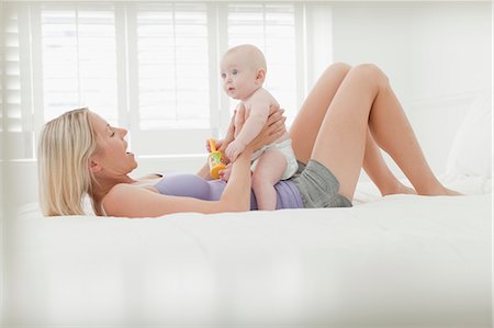 simsearch:6113-07543218,k - Mother playing with baby on bed Stock Photo - Premium Royalty-Free, Code: 6122-07705791