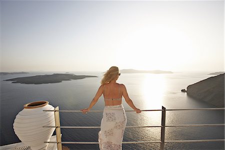 sarong - Woman admiring ocean view from balcony Stock Photo - Premium Royalty-Free, Code: 6122-07705968