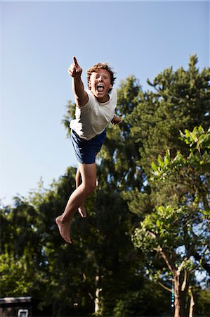 simsearch:649-07647801,k - Teenage boy pointing in mid-air Stock Photo - Premium Royalty-Free, Code: 6122-07705998