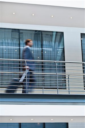 simsearch:649-06040639,k - Blurred view of businessman on balcony Stock Photo - Premium Royalty-Free, Code: 6122-07706169