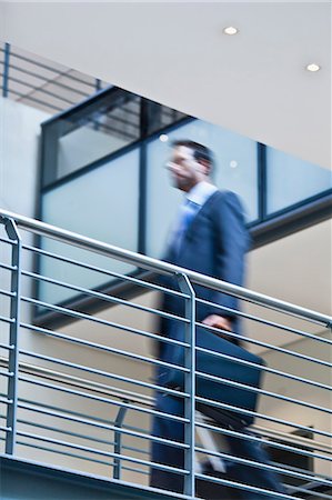 simsearch:649-06040639,k - Blurred view of businessman on balcony Stock Photo - Premium Royalty-Free, Code: 6122-07706170