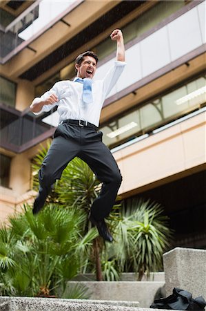 simsearch:6113-07648679,k - Businessman jumping for joy outdoors Stock Photo - Premium Royalty-Free, Code: 6122-07706226