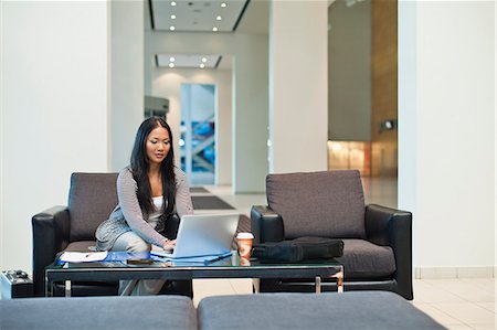simsearch:649-05648787,k - Businesswoman working in lobby Stock Photo - Premium Royalty-Free, Code: 6122-07706348