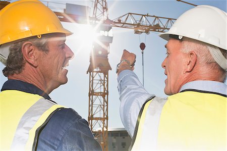 simsearch:649-06040720,k - Workers talking on construction site Stock Photo - Premium Royalty-Free, Code: 6122-07706392