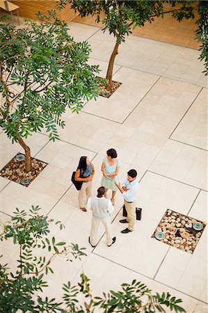 simsearch:6122-07706325,k - Business people talking in lobby Stock Photo - Premium Royalty-Free, Code: 6122-07706336