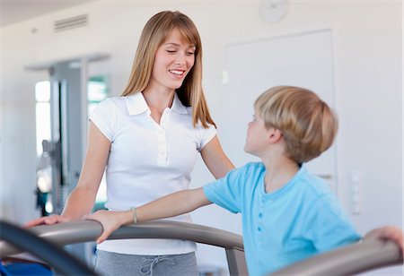 simsearch:649-06041068,k - Trainer working with boy in gym Stock Photo - Premium Royalty-Free, Code: 6122-07706459