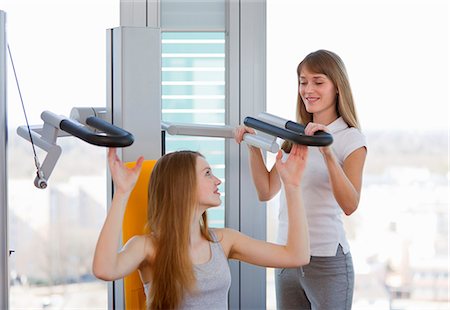 simsearch:649-06041068,k - Trainer working with girl in gym Stock Photo - Premium Royalty-Free, Code: 6122-07706462