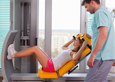simsearch:649-06041068,k - Trainer working with woman in gym Stock Photo - Premium Royalty-Free, Code: 6122-07706469