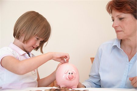 simsearch:628-07072734,k - Daughter putting money in piggy bank Stock Photo - Premium Royalty-Free, Code: 6122-07706424
