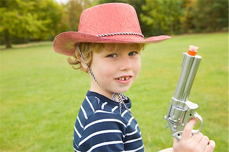 simsearch:649-06041783,k - Boy playing with toy gun outdoors Stock Photo - Premium Royalty-Free, Code: 6122-07706547