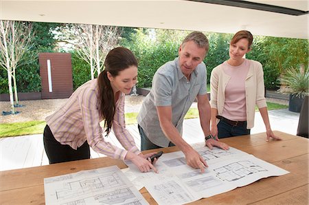simsearch:6108-06907863,k - Business people reading blueprints Stock Photo - Premium Royalty-Free, Code: 6122-07706582