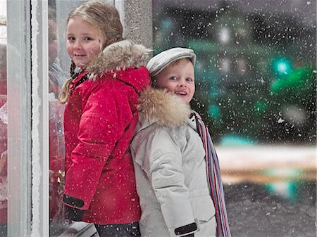 Children smiling in snow Stock Photo - Premium Royalty-Free, Code: 6122-07706500