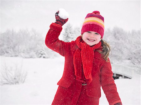 simsearch:6113-06899345,k - Smiling girl throwing snowball Stock Photo - Premium Royalty-Free, Code: 6122-07706509