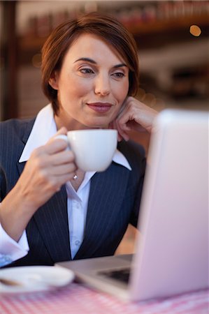 simsearch:649-05648787,k - Businesswoman using laptop in cafe Stock Photo - Premium Royalty-Free, Code: 6122-07706737