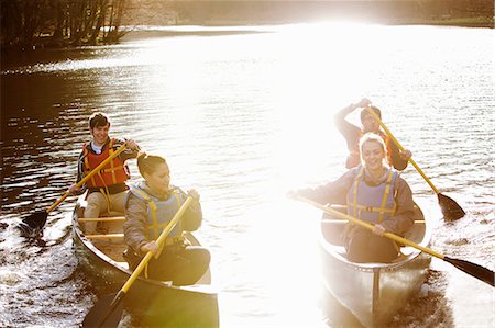 simsearch:6122-07699789,k - Friends rowing canoes on still lake Stock Photo - Premium Royalty-Free, Code: 6122-07707043