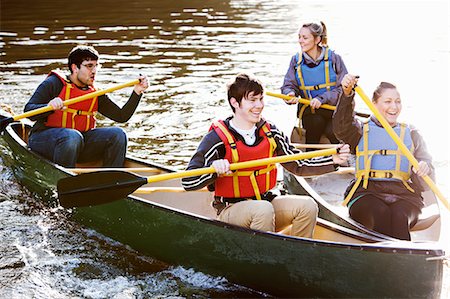 simsearch:6122-07699789,k - Friends rowing canoes on still lake Stock Photo - Premium Royalty-Free, Code: 6122-07707042