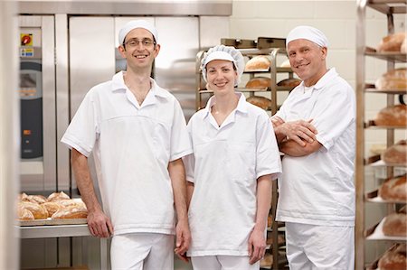 simsearch:649-06165027,k - Chefs smiling together in kitchen Stock Photo - Premium Royalty-Free, Code: 6122-07707501
