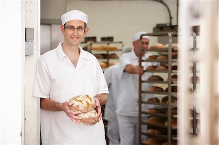 simsearch:649-06165027,k - Chef holding loaves of bread in kitchen Stock Photo - Premium Royalty-Free, Code: 6122-07707504