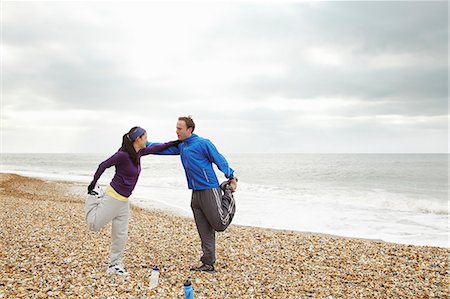 fitness asian couple - Couple stretching on beach on cloudy day Stock Photo - Premium Royalty-Free, Code: 6122-08211849