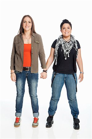 Lesbian couple holding hands against white background Stock Photo - Premium Royalty-Free, Code: 6122-08212559