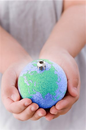 Girl holding globe decoration Stock Photo - Premium Royalty-Free, Code: 6122-08212889