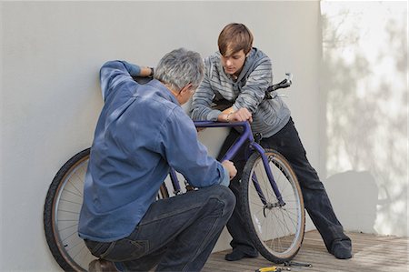 simsearch:649-05656972,k - Father helping son repair bicycle Stock Photo - Premium Royalty-Free, Code: 6122-08229117