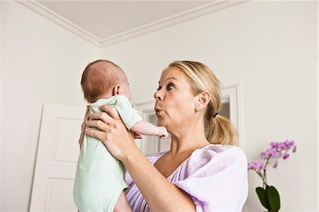 simsearch:6113-07543205,k - Mother holding infant in bedroom Stock Photo - Premium Royalty-Free, Code: 6122-08229316