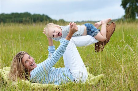 simsearch:6113-07961722,k - Mother and son playing in grass Stock Photo - Premium Royalty-Free, Code: 6122-08229473