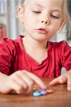 simsearch:649-05520883,k - Girl playing with candies on table Stock Photo - Premium Royalty-Free, Code: 6122-08229750