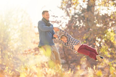 simsearch:649-07647801,k - Father spinning son among autumn leaves Stock Photo - Premium Royalty-Free, Code: 6124-08170380