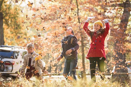 simsearch:6113-07542775,k - Boys and girl throwing autumn leaves overhead Stock Photo - Premium Royalty-Free, Code: 6124-08170390