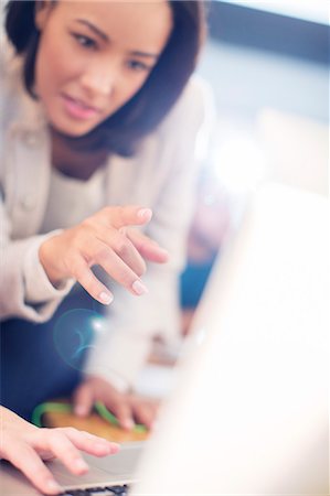 person concentrating computer - Focused businesswoman pointing at laptop Stock Photo - Premium Royalty-Free, Code: 6124-08170766