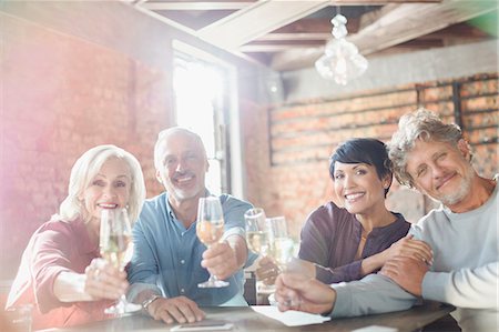 simsearch:6113-07242109,k - Portrait smiling couples toasting white wine glasses at restaurant table Stock Photo - Premium Royalty-Free, Code: 6124-08743183
