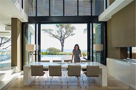 rich lifestyle - Businesswoman working at dining table in home showcase interior Stock Photo - Premium Royalty-Free, Code: 6124-08743266