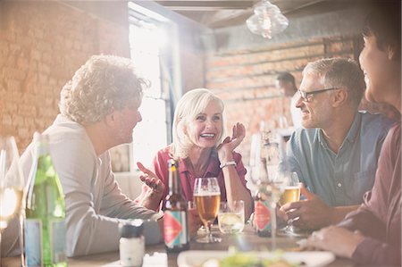 simsearch:6113-07147381,k - Couples talking and drinking beer at restaurant table Stock Photo - Premium Royalty-Free, Code: 6124-08743215