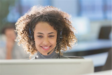 face to internet technology - Businesswoman with headset working at computer in office Stock Photo - Premium Royalty-Free, Code: 6124-08703952