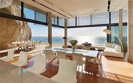 simsearch:6124-08703974,k - Modern luxury home showcase dining room and living room with sunny ocean view Stock Photo - Premium Royalty-Free, Code: 6124-08703983