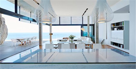 Modern luxury living room open to patio with ocean view Stock Photo - Premium Royalty-Free, Code: 6124-08703994