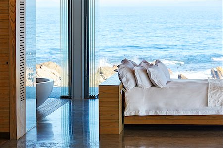 simsearch:6124-08703974,k - Modern luxury home showcase bed with ocean view Stock Photo - Premium Royalty-Free, Code: 6124-08704044