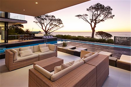 simsearch:6124-08703974,k - Modern luxury home showcase patio and swimming pool overlooking ocean view at sunset Stock Photo - Premium Royalty-Free, Code: 6124-08704015