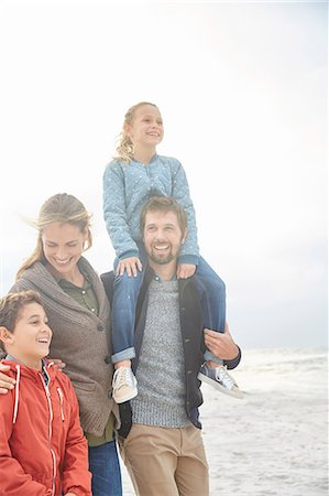 simsearch:649-07803505,k - Smiling family walking on winter beach Stock Photo - Premium Royalty-Free, Code: 6124-08805246