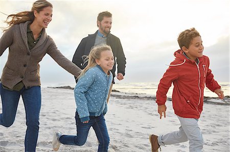 simsearch:649-07803505,k - Playful family running on winter beach Stock Photo - Premium Royalty-Free, Code: 6124-08805249