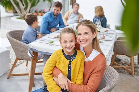 simsearch:6113-06909372,k - Portrait smiling mother and daughter hugging at patio lunch Stock Photo - Premium Royalty-Free, Code: 6124-08805262