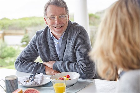 enjoying retirement - Senior couple eating breakfast on patio Stock Photo - Premium Royalty-Free, Code: 6124-08805218