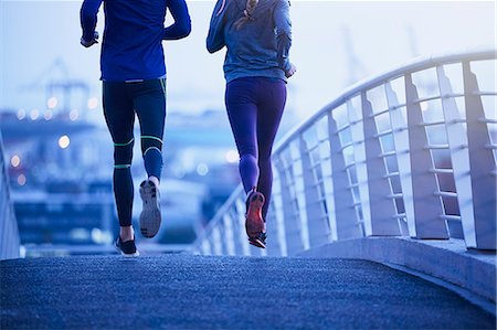 simsearch:633-01715682,k - Runner couple running on urban footbridge at dawn Stock Photo - Premium Royalty-Free, Code: 6124-08820841