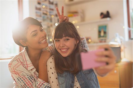 simsearch:6113-06908601,k - Playful young women taking selfie with camera phone Stock Photo - Premium Royalty-Free, Code: 6124-08820999
